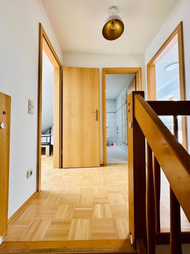 a hallway with a wooden floor and a staircase at Massive Karli Loft - over 130 meters floor space - home theater room - 4 private sleeping areas - best location in Leipzig in Leipzig