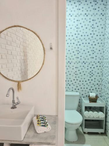 a bathroom with a sink and a toilet and a mirror at Yabás Praia in Ubatuba