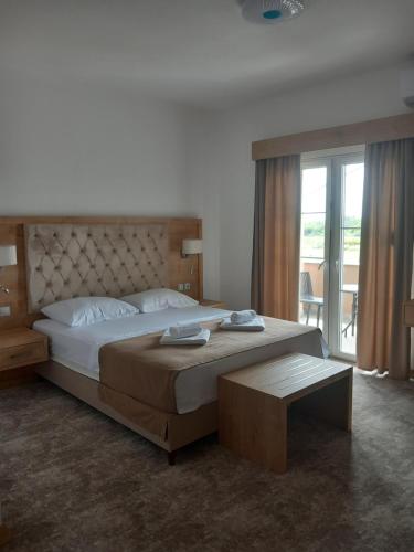 a bedroom with a large bed and a large window at Haus Carla in Ulcinj