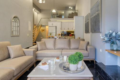 a living room with two couches and a table at Villa Hope in Chania in Mourniaí