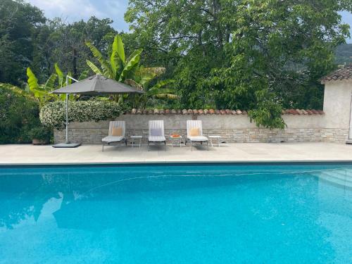 deux chaises et un parasol à côté d'une piscine dans l'établissement Romantic cottage for couples, à Vence