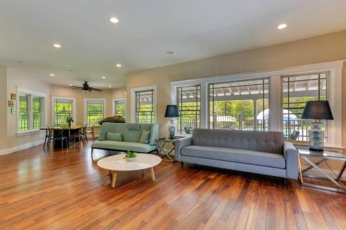 a living room with two couches and a table at Experience the Charm of a Cozy Hudson Valley Vacation Retreat in Gardiner