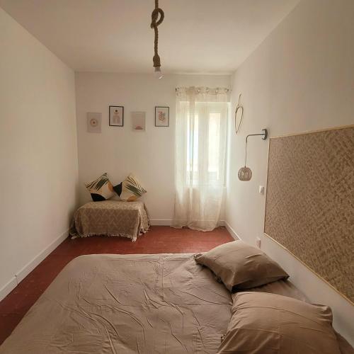 a bedroom with a bed and a window at Jolie maison de vacances 4-5 personnes in Saint-Marcel