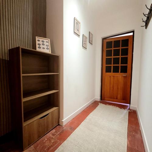 a room with a book shelf and a door at Jolie maison de vacances 4-5 personnes in Saint-Marcel