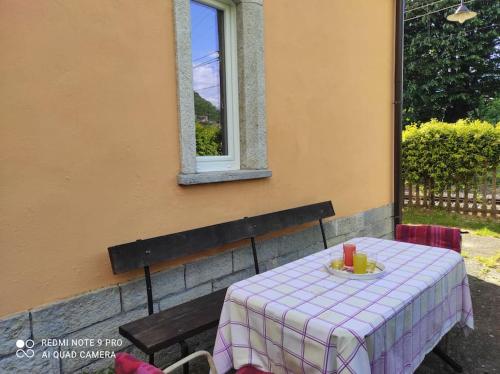 a table with a plate of food on it next to a window at Chilometro 29 aria in Dervio