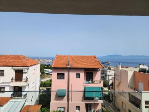 a view from the balcony of a pink building at Pinecone in Kavala