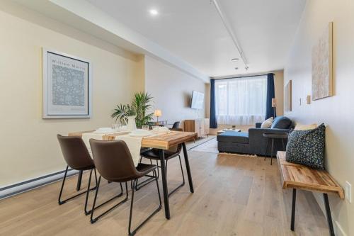 a living room with a table and chairs and a couch at Double King Luxury 2BR Condo in Montréal