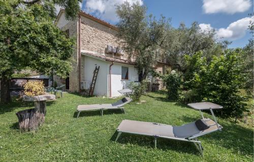 a garden with two lounge chairs and a building at 1 Bedroom Gorgeous Home In Montebuono in Montebuono