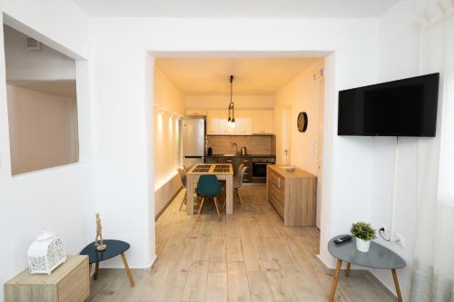 a living room with a table and a kitchen at Merchia Bay Villas Mykonos in Merchia Beach