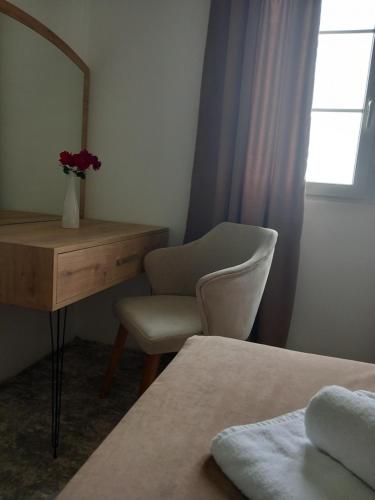 a bedroom with a desk and a chair and a mirror at Haus Carla in Ulcinj