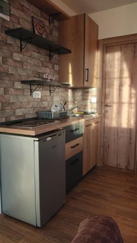 a kitchen with a stove and a counter top at Guest House Stevovski in Ohrid