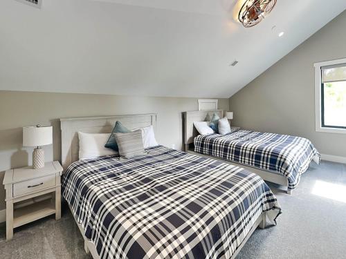 a bedroom with two beds and a window at Heavenly Summit in McHenry