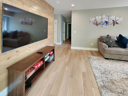 a living room with a large flat screen tv at Heavenly Summit in McHenry
