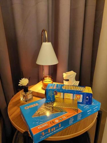 a table with two boxes of cereal and a lamp at 1014 - Cavite Minimalist Condo with Resort-like Amenities & Hi Speed Wifi in Dasmariñas