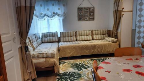 a living room with a couch and a table at Maison charmante à Saint-Martin-des-Entrées in Saint-Martin-des-Entrées