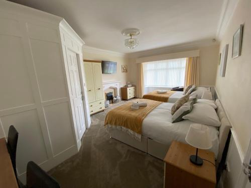 a bedroom with a large bed and a window at Parkside Guest House in Pollington