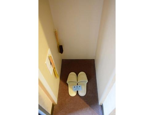 a pair of shoes sitting on the floor in a hallway at Hotel Migrant - Vacation STAY 81252v in Tateyama