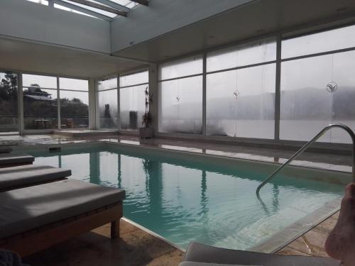 a swimming pool with a hose in a building at Veneto Village Departamento in Villa Parque Siquiman