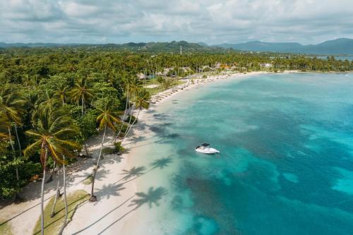 an aerial view of a beach with a boat on it at Wyndham Alltra Samana All Inclusive Resort in Las Galeras