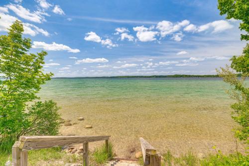 a view of the ocean from the beach at Alden Home with Fire Pit Steps to Torch Lake! in Alden