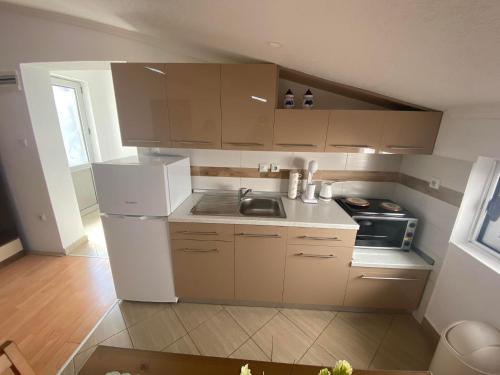 a small kitchen with a sink and a refrigerator at SIENA Apartment in Gevgelija