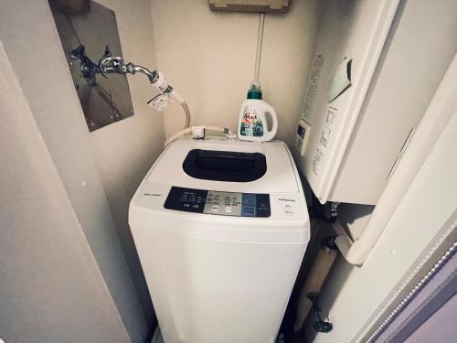 a washer and dryer in a small bathroom at shinjuku kabukicho 205 in Tokyo