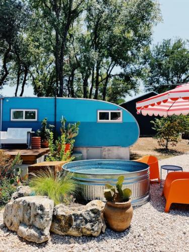 an rv with a pool in a yard with plants at Renovated Spartan BB in Austin