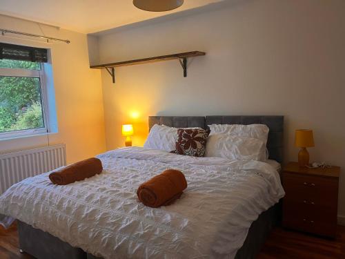 a bedroom with a bed with two pillows on it at Amani Bungalow in Brandon