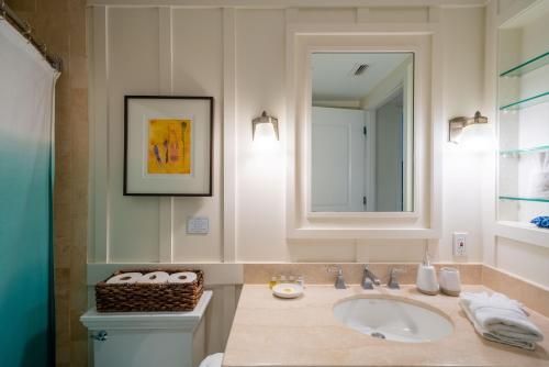 a bathroom with a sink and a mirror at Stunning Luxurious Ocean Villa with Ocean Views From All bedrooms. in Kahuku