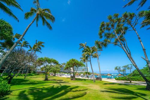 a park with palm trees and the ocean in the background at Stunning Luxurious Ocean Villa with Ocean Views From All bedrooms. in Kahuku