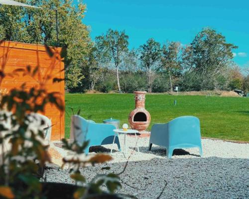 a group of chairs and a table in a yard at Silo House "Opal" in Austin