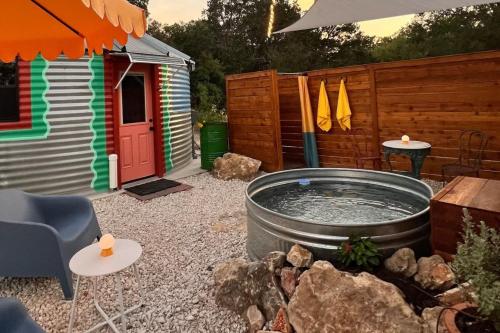 a backyard with a hot tub and a house at Silo House "Opal" in Austin
