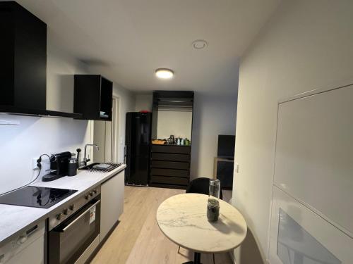 a small kitchen with a table and a counter top at Ny og moderne studio leilighet ! in Fetsund