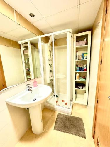 a bathroom with a white sink and a shower at Mar y desconexión in San Javier