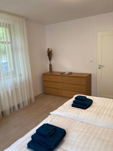 two blue towels sitting on two beds in a room at Ústí nad Labem, Apartmány pod hradem Střekovem in Ústí nad Labem