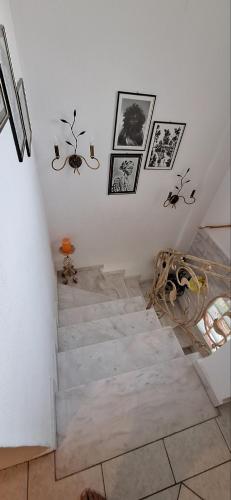 a staircase in a room with pictures on the wall at Eleochori View Sea in Elaiokhórion