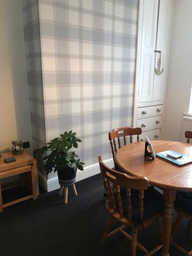 an office with a table and chairs and a plant at BeRo Terrace, only a minutes walk to the beach! in Withernsea