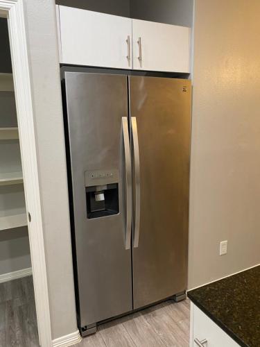 a large stainless steel refrigerator in a kitchen at Cozy Getaway with King Bed near UTRGV in Edinburg