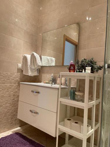 a bathroom with a sink and a mirror at The garden corner in Bouznika