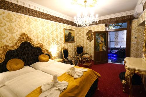 a bedroom with a bed with white sheets and a chandelier at Hotel Liliova Prague Old Town in Prague