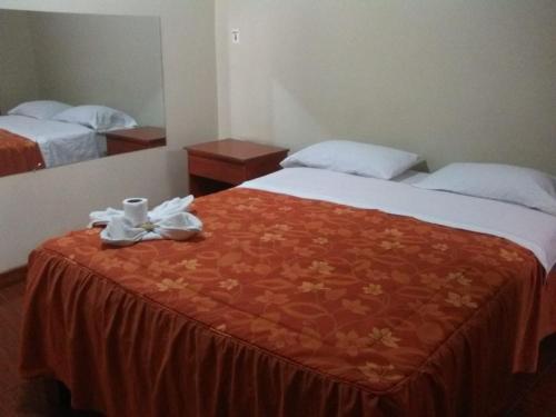 a hotel room with two beds with towels on the bed at Hostal Jara in Lima