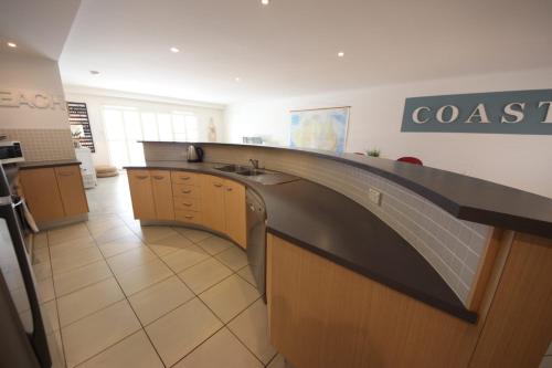 a kitchen with a sink and a counter in a room at Jubilee Apartment 10 2 Paragon Ave SWR in South West Rocks