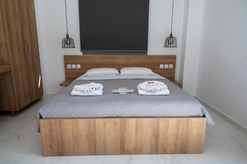 a bedroom with a bed with two towels on it at Finikas Suites & Apartments Airport By Airstay in Artemida