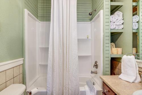 a bathroom with a shower curtain and a toilet at Main Street Home 1 Mile to Callaway Gardens in Pine Mountain