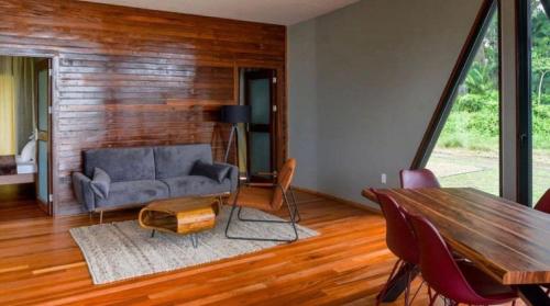 a living room with a couch and a table at Houttuyn Wellness River Resort in Paramaribo