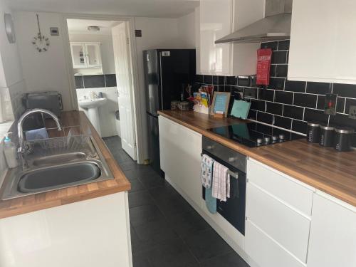 a kitchen with a sink and a counter top at BeRo Terrace, only a minutes walk to the beach! in Withernsea