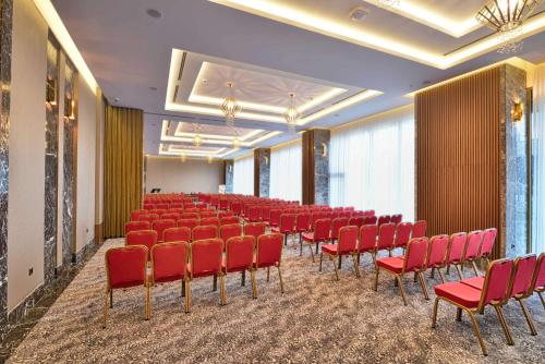 a conference room with red chairs in a row at Best Western Premier Ottoperla Hotel in Istanbul