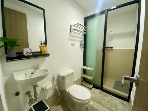 a bathroom with a toilet and a sink and a shower at J & F Homestay - Cavite, Philippines in Trece Martires