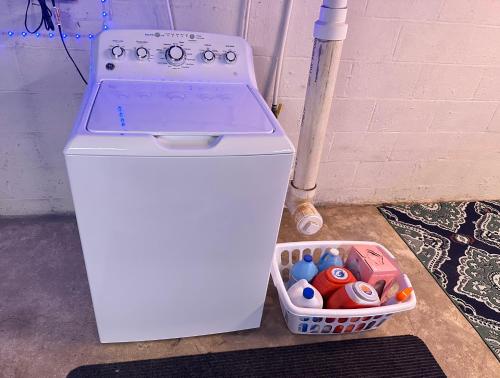 a white stove next to a basket of toys at Little Elves Overlook in Sparta