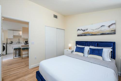 una camera da letto con un letto grande e una cucina di Cozy 4 Bedroom Near to Disney, Arcade and Games! a Fullerton